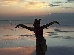 mature women dancing under pink sky with white salt