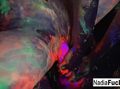 Nadia White and Ophelia suck a colorful cock under black lights