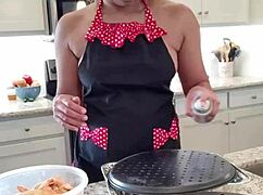 Kara cooking chicken wings in the kitchen