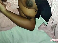 Angolan woman enjoys morning breast massage in interracial setting.