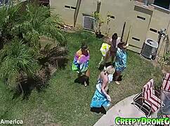 Lesbians are filmed by a drone in the outdoor pool for amateur video