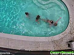 Lesbians are filmed by a drone in the outdoor pool for amateur video