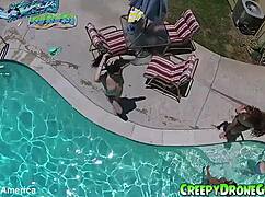 Lesbians are filmed by a drone in the outdoor pool for amateur video
