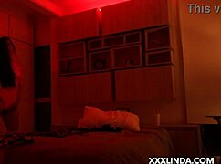 Linda Houston dances seductively under the red light with her couple