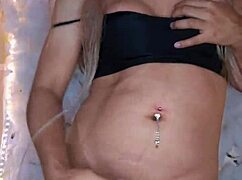 Intriguing view of hermosa travesti in crossdressing, touching her body softly