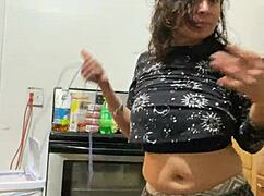 Anna Maria, that mature black Latina, teases with her big tits and ass in workout apparel.