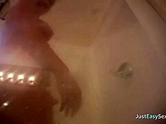 Curvy blonde babe masturbates while bathing in the shower