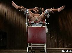 ebony babe endures crotch rope and tight hogtie in bizarre setup.