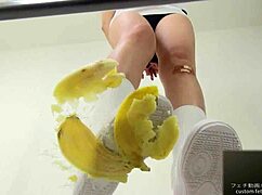 asian girl crushes banana in wild food fetish play
