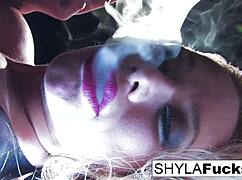 Shyla Stylez shows off big tits and ass in solo fetish smoking scene.