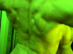 Busty ginger milf shows off massive muscles flexing in the mirror. Her big tits steal the spotlight.