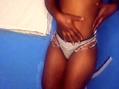 Ebony girl stands while stroking pussy