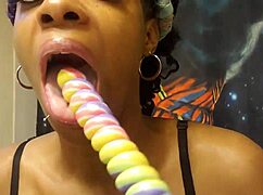 An ebony babe samples a unicorn lollipop with sucking.