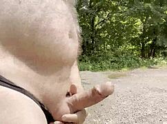 Gay guy strokes monster cock in the woods