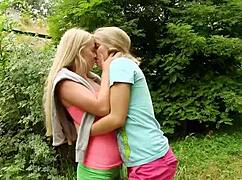 Aroused blonde lesbians pound wet 18+ pussies with toys outdoors