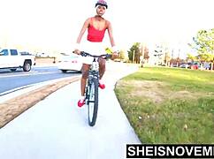 just a tiny ebony babe riding a bike with her booty out in public!