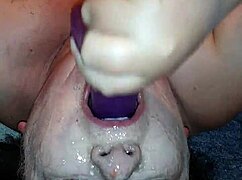 Ms. TL demonstrates throat techniques with toys and dildos in a messy setup