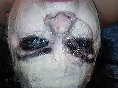 Ms. TL demonstrates throat techniques with toys and dildos in a messy setup