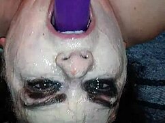 Ms. TL demonstrates throat techniques with toys and dildos in a messy setup