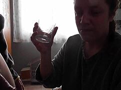 He performs oral and drinks in a glass.