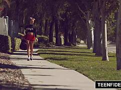 Cute cheerleader liza rowe shakes her pom poms