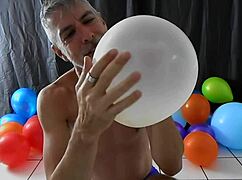 richard lennox, horny gay dilf, indulges in balloon play with monster cock.
