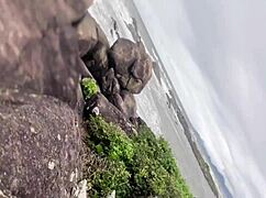 A busty young girl flashes her big ass and tits on the public beach, getting caught