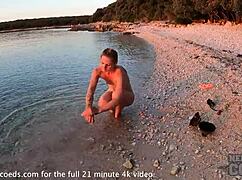 Pretty european girl performs nude fire dancing on usa beach at sunset