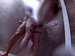 Intense passion with a client in the gym showers, feeling the heat and desire