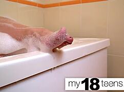 Cute redhead teen masturbates to orgasm in the bath closeup