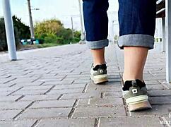 feet goddess teases with tan nylon soles and blue jeans on the bench