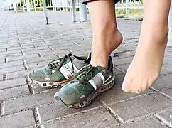 feet goddess teases with tan nylon soles and blue jeans on the bench