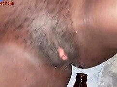 Ghana ebony girl fucks malt bottle with her ass!