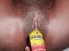 Ghana ebony girl fucks malt bottle with her ass!
