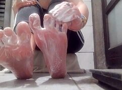 sexy woman teases with feet and lubricates her big ass