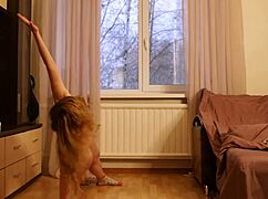 Naked gymnast performs flexible yoga workout in sport.