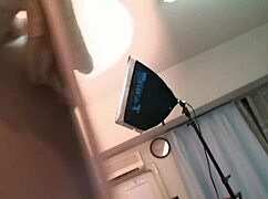 Young Asian plays with vibrators alone