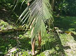 A naked tall girl is photographed in the wild amazon jungle.
