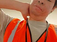 an asian woman casually walking around outdoors during her work shift