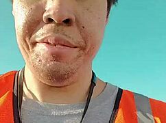 an asian woman casually walking around outdoors during her work shift