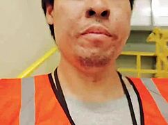 an asian woman casually walking around outdoors during her work shift