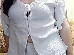 Horny brunette stripteases