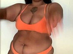 the black pornstar in bikini dances seductively, showing off her big tits and ass