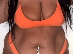 the black pornstar in bikini dances seductively, showing off her big tits and ass