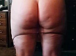 The brunette with a big sexy ass performs an enticing booty drop in the scene.