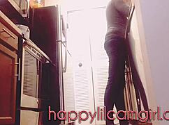 tall girl dominates kitchen cleaning while recording voyeur webcam.