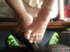 this ebony babe gives an excellent footjob, teasing with her feet at home