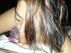 My wife gives a rich blowjob with her mouth on my cock in our bedroom. She uses her tongue skillfully.