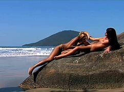 Young women enjoy intimate seaside moments