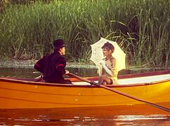 A beautiful girl with small 18+ tits rode a strong man on a boat